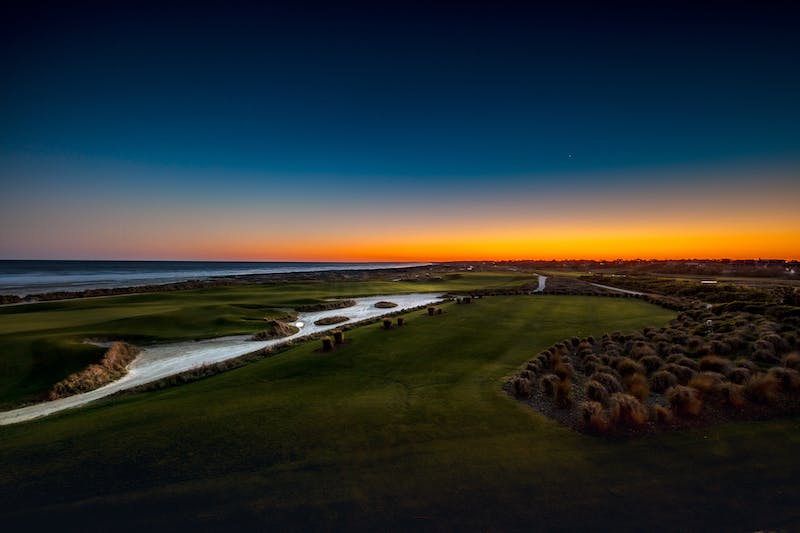 Golf course overlooking the ocean at sunset